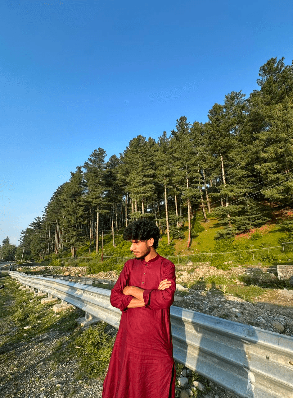 Koshur Nizam founder standing among the pine forests of Kashmir