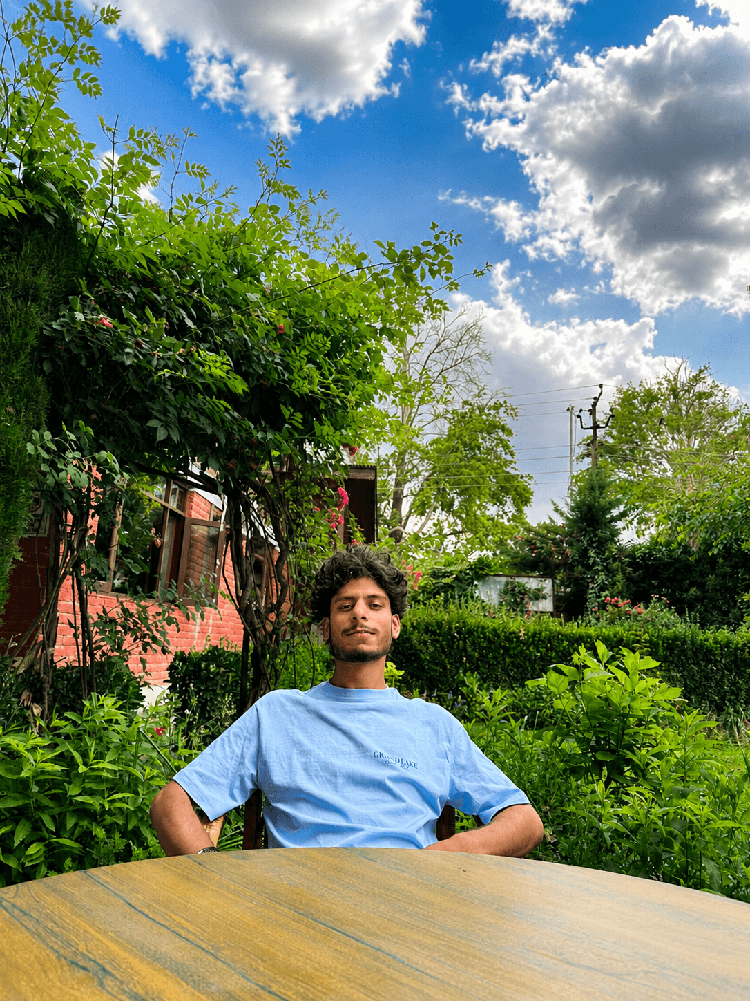 Mir Aarish, founder of Koshur Nizam, seated in a Kashmir garden